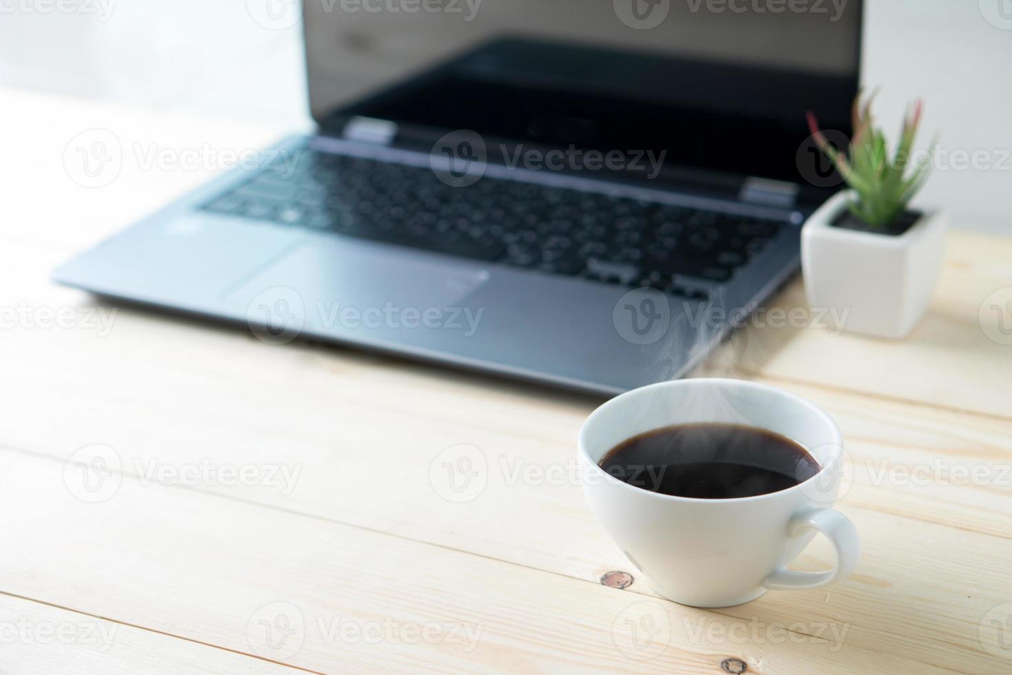 Laptop with blank screen on table interior photo