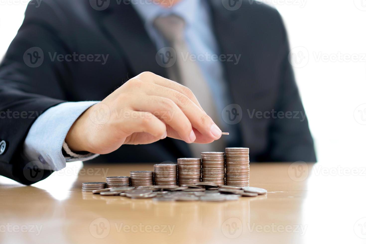 Hand putting stack of coins photo