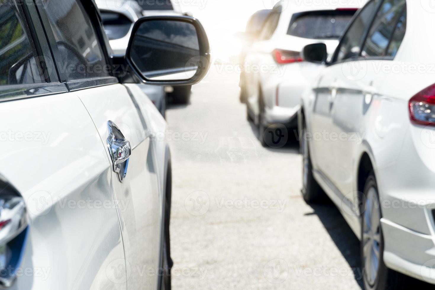 Beside of several vehicles line up on asphalt roads during traffic jams. Outdoor atmosphere during the day when the sun shines brightly. heading for the road ahead. photo