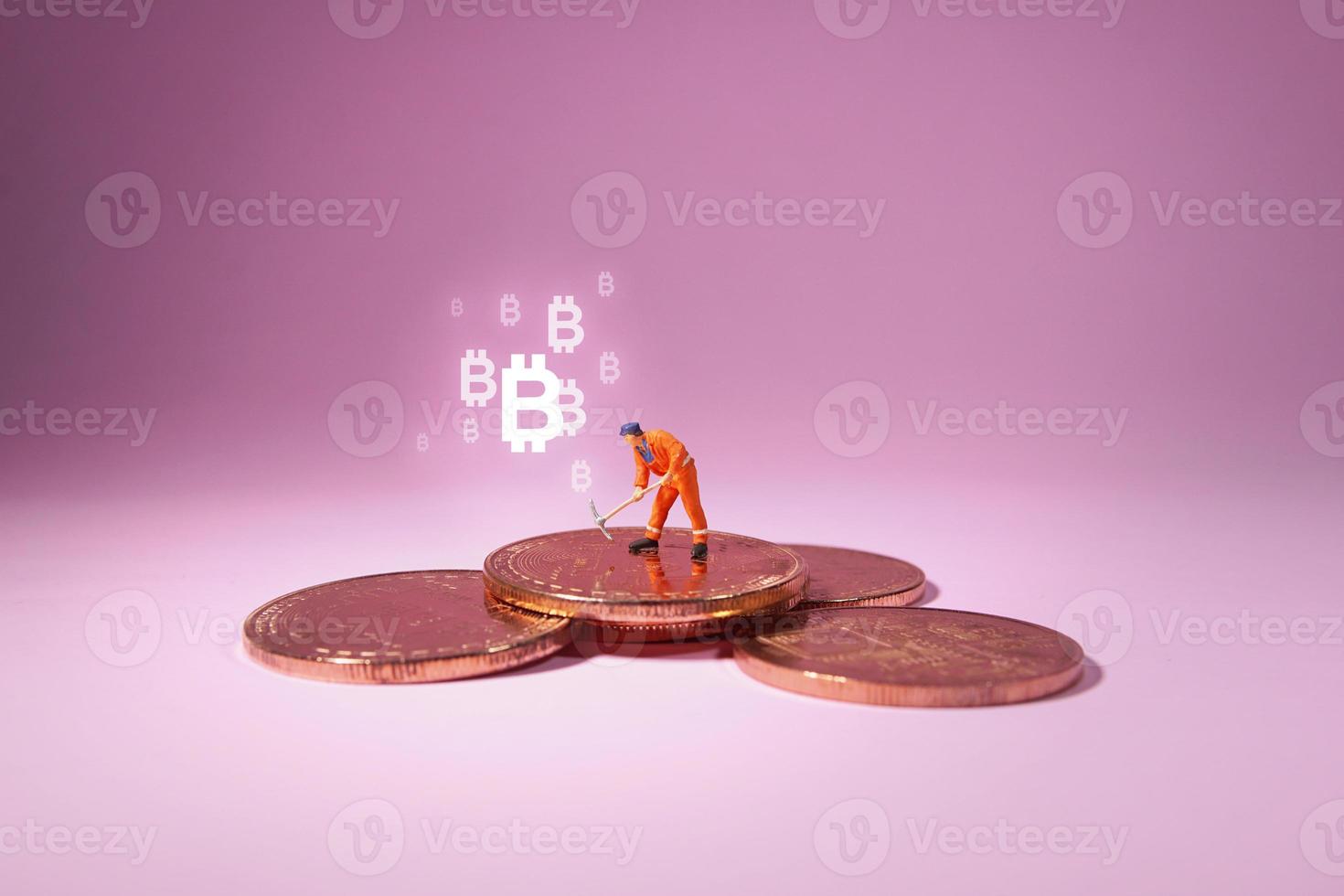 Technician worker figure standing on bitcoin. Bitcoin mining concept. photo