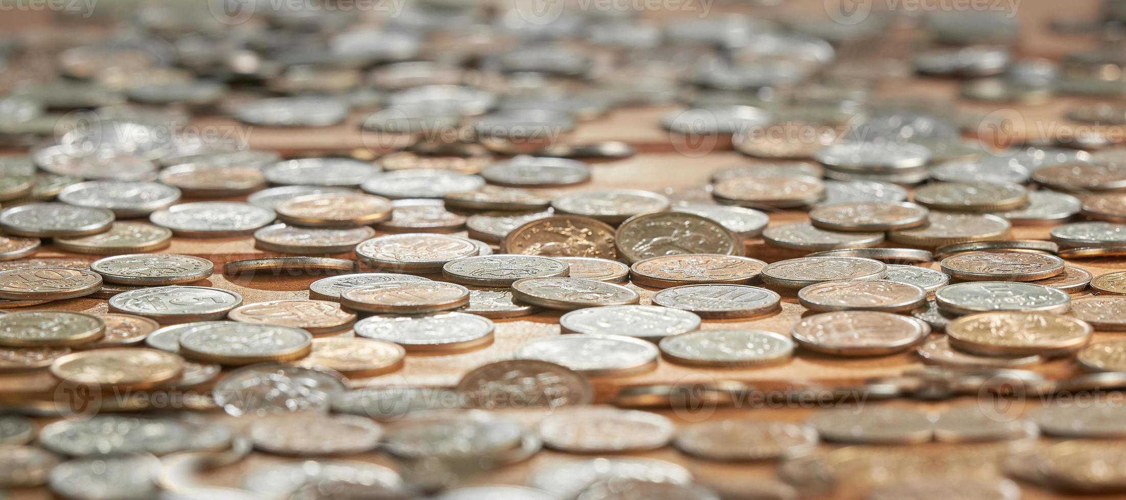 Close up side view image of large amount of coins. photo