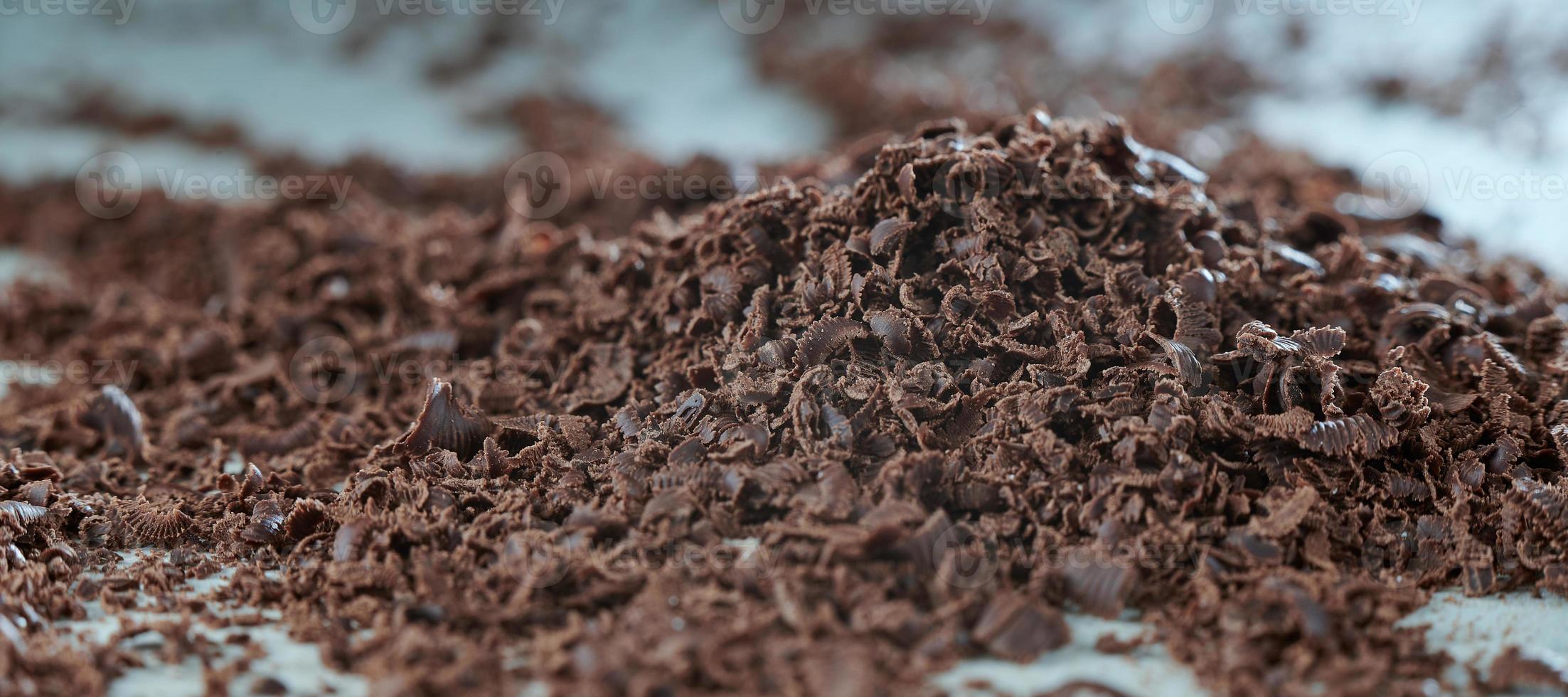 Grated chocolate close-up. The blank for the cake. The background in blur. photo