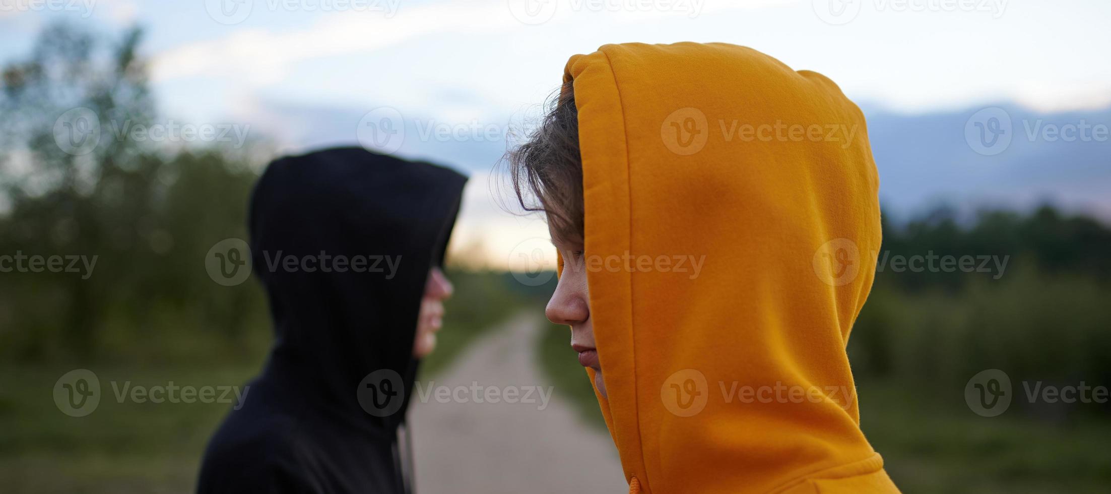 Two teenagers outdoors. Youth fashion. The concept of a quarrel. Problems of transitional age. photo