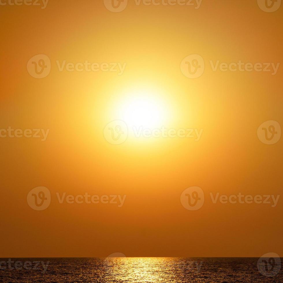 Orange sunset in blur over the sea. Beautiful monochrome background. photo