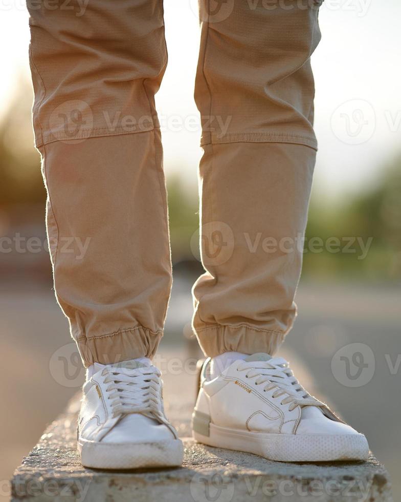 Feet man standing on concrete block. The concept of urban style. photo