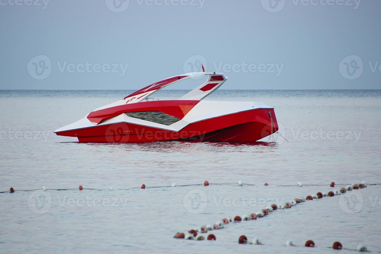 A lonely empty modern boat on the sea in the evening. The concept of a work ban. photo