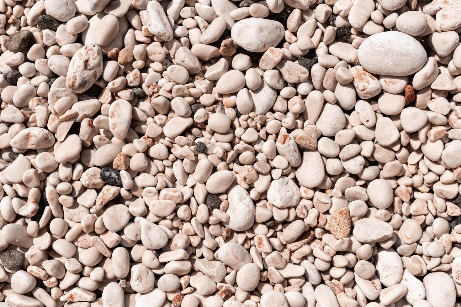 background of pebble stones on the beach photo