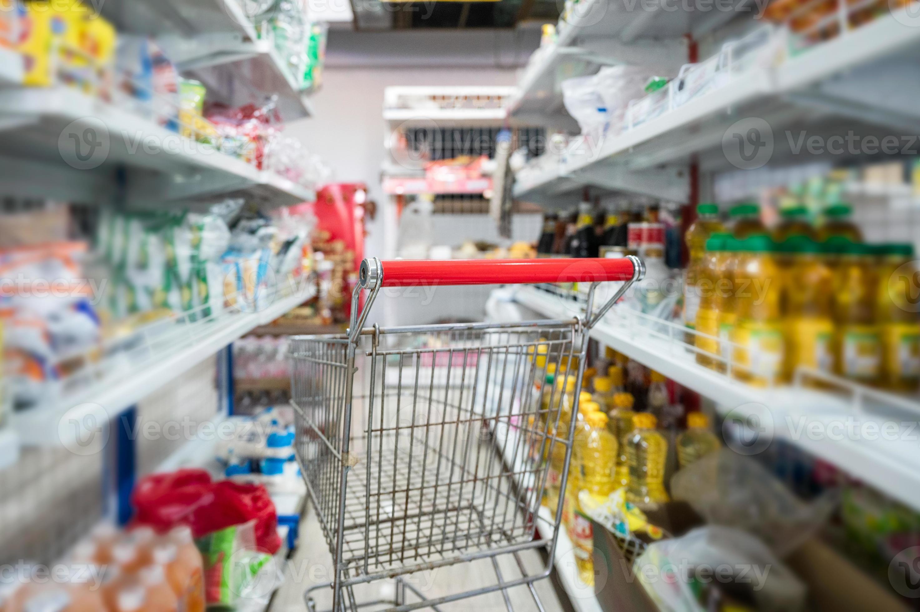 Shopping cart parked in aisle food and raw material at grocery