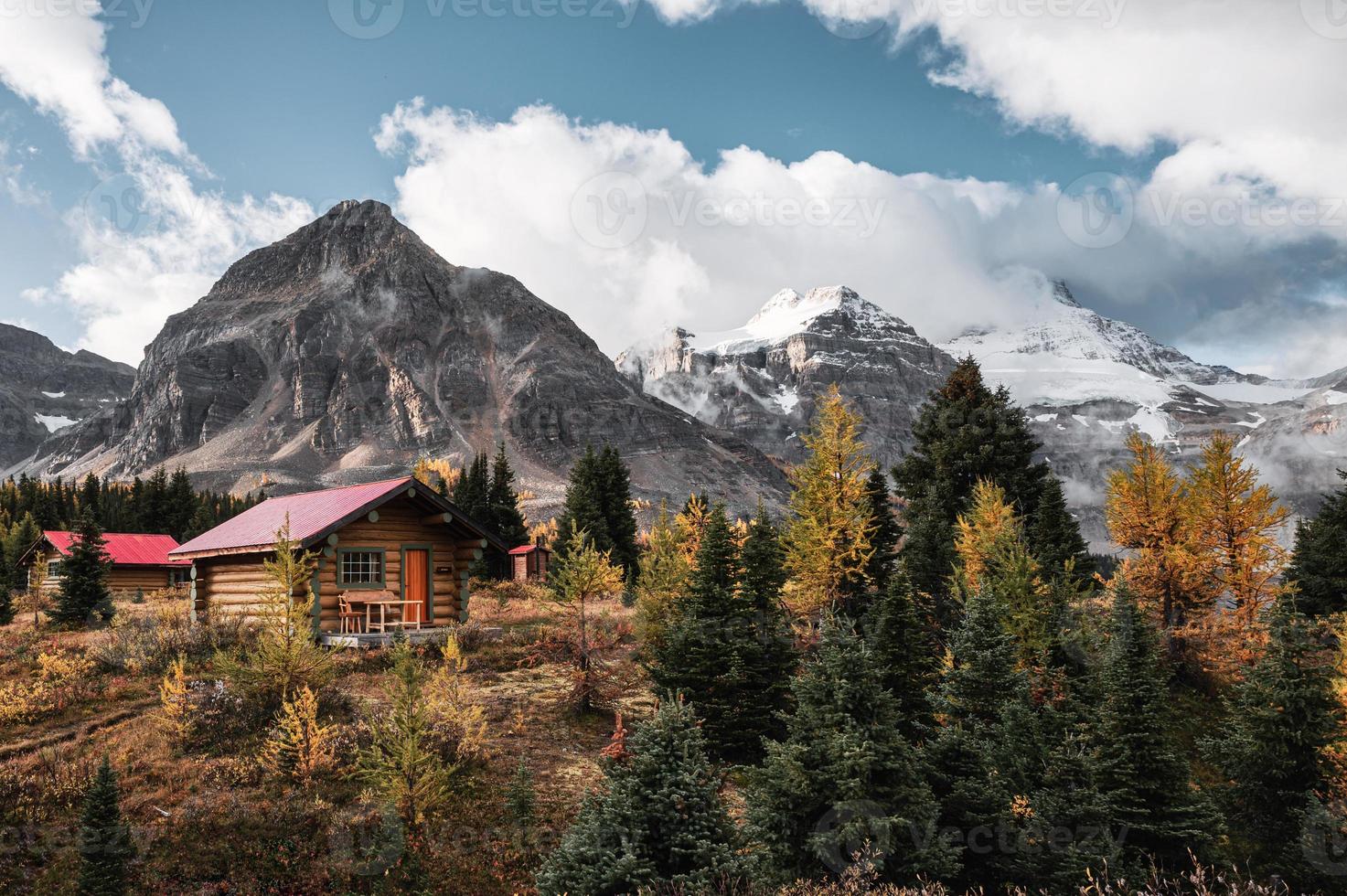 Wooden huts with Rocky mountains in autumn forest at Assiniboine provincial park photo