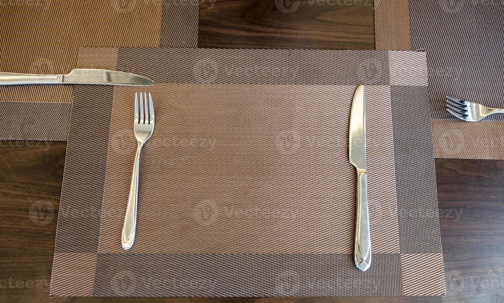 Tableware knife and fork with table cloth on wood table photo