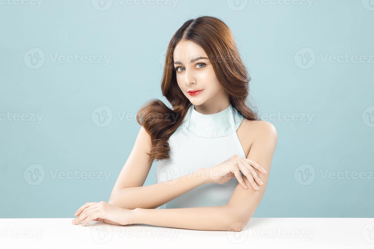 Beautiful  young woman model with clean fresh skin on blue background, Female portrait Face care, plastic surgery Facial treatment, Cosmetology, beauty and spa. photo