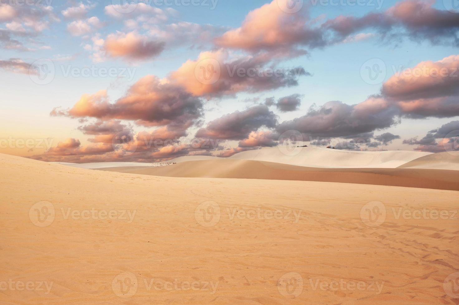 Sand dune with colorful cloud in sky on desert photo