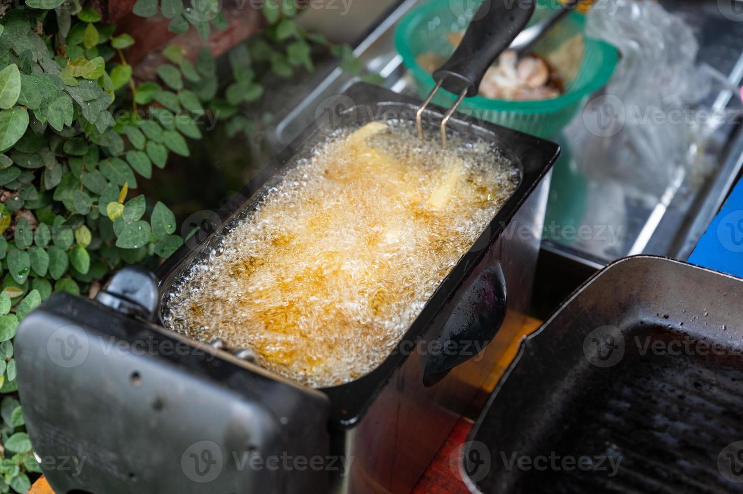 Deep frying French Fries in deep fryer photo