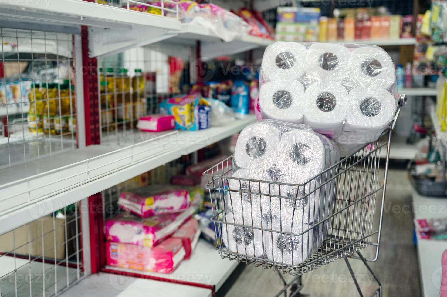 Customer hoarding tissue, toilet paper on shopping cart in retailer photo