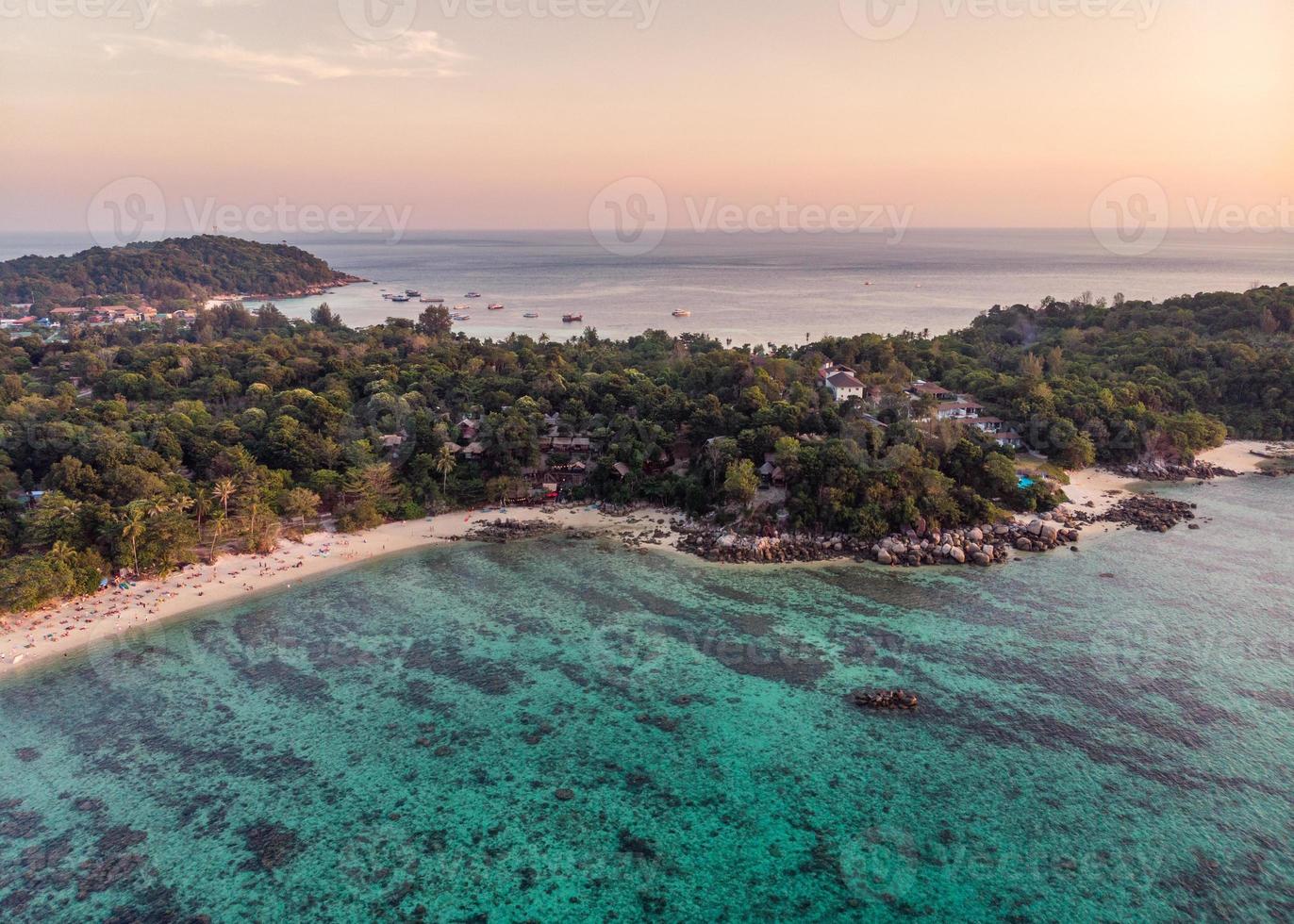 Beautiful tropical sea with coral reef at sunset photo