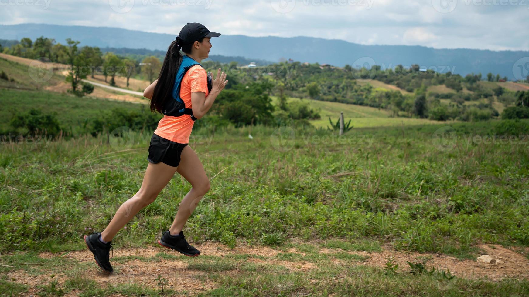 Young women active trail runners the top of a mountain in the afternoon, ultra marathon runners adventuring outdoors photo
