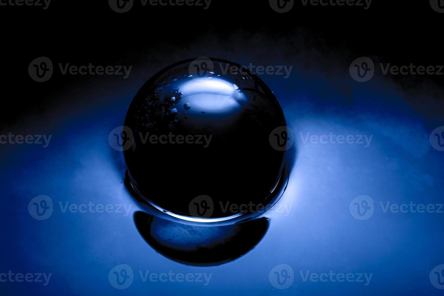 Abstract image of a glass ball, Crystan ball in dark blue. photo