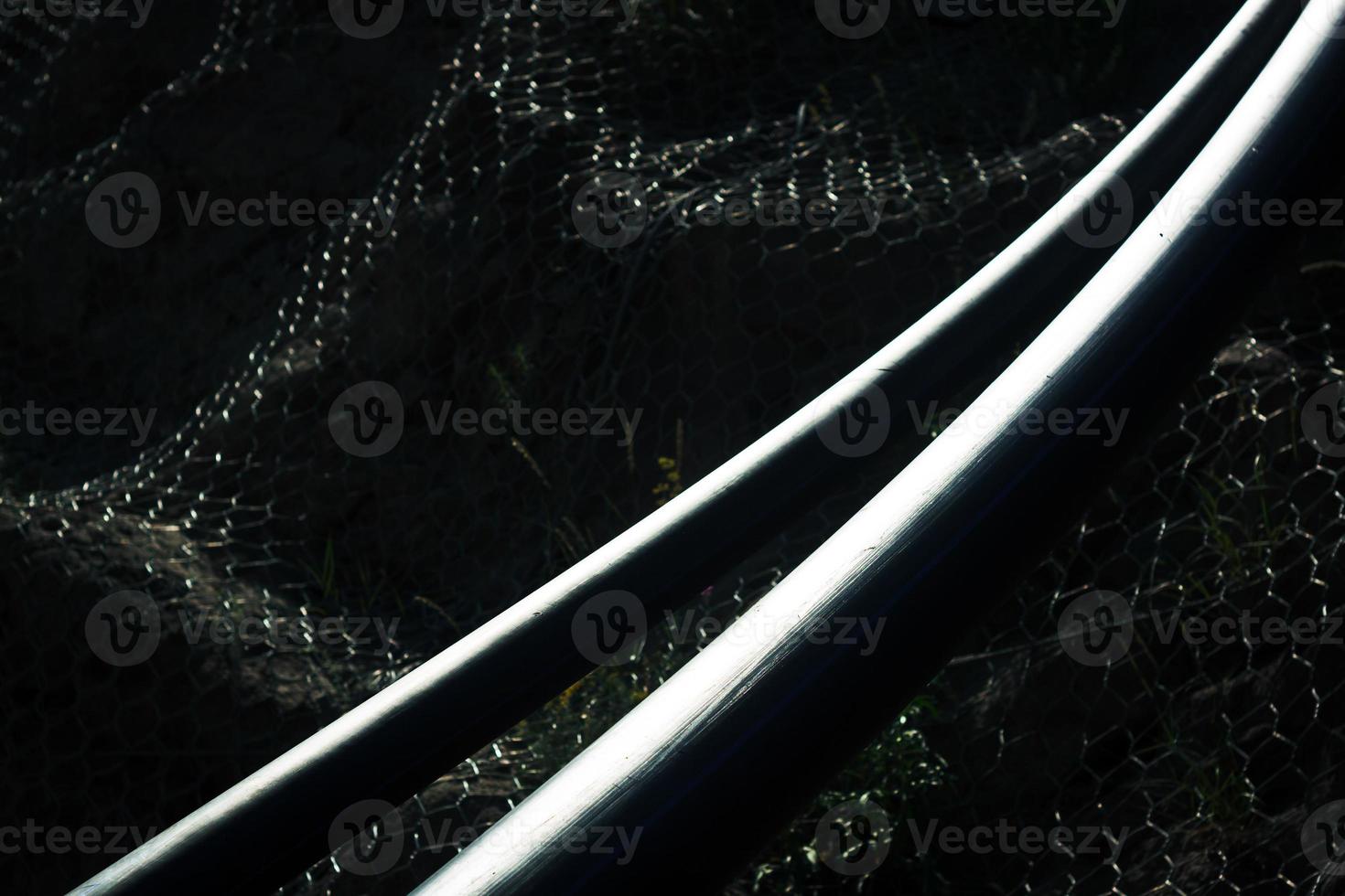 High contrast image of two platic water pipes on dark background. photo