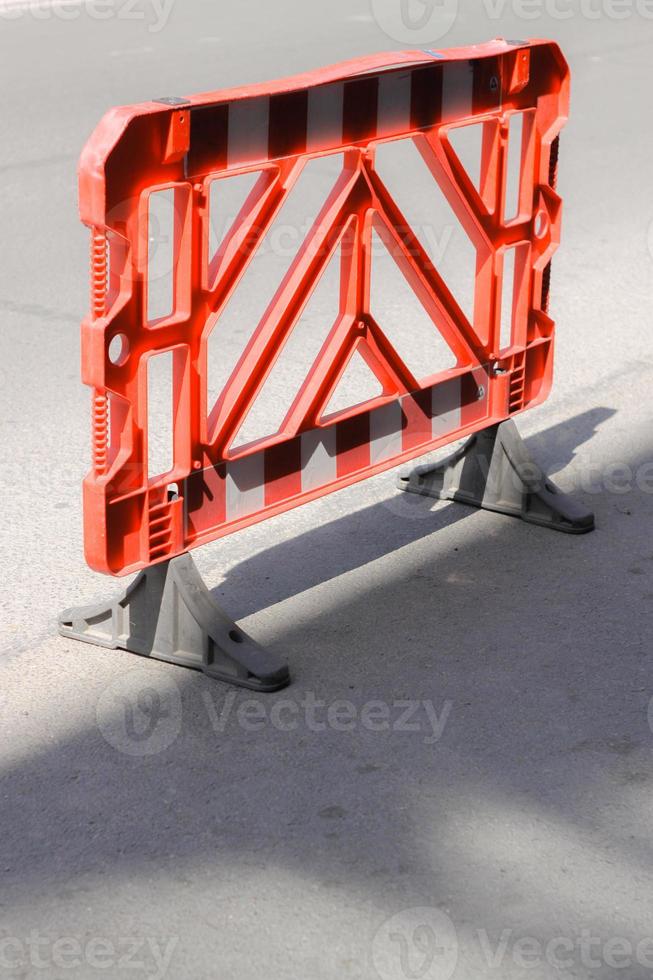 Red plastic reguration barrier on the road. photo