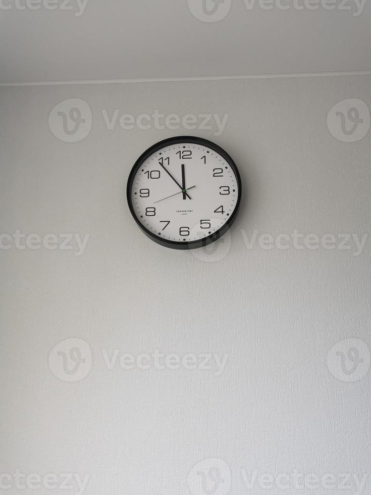 clock hanging on the wall in the kitchen in the apartment photo