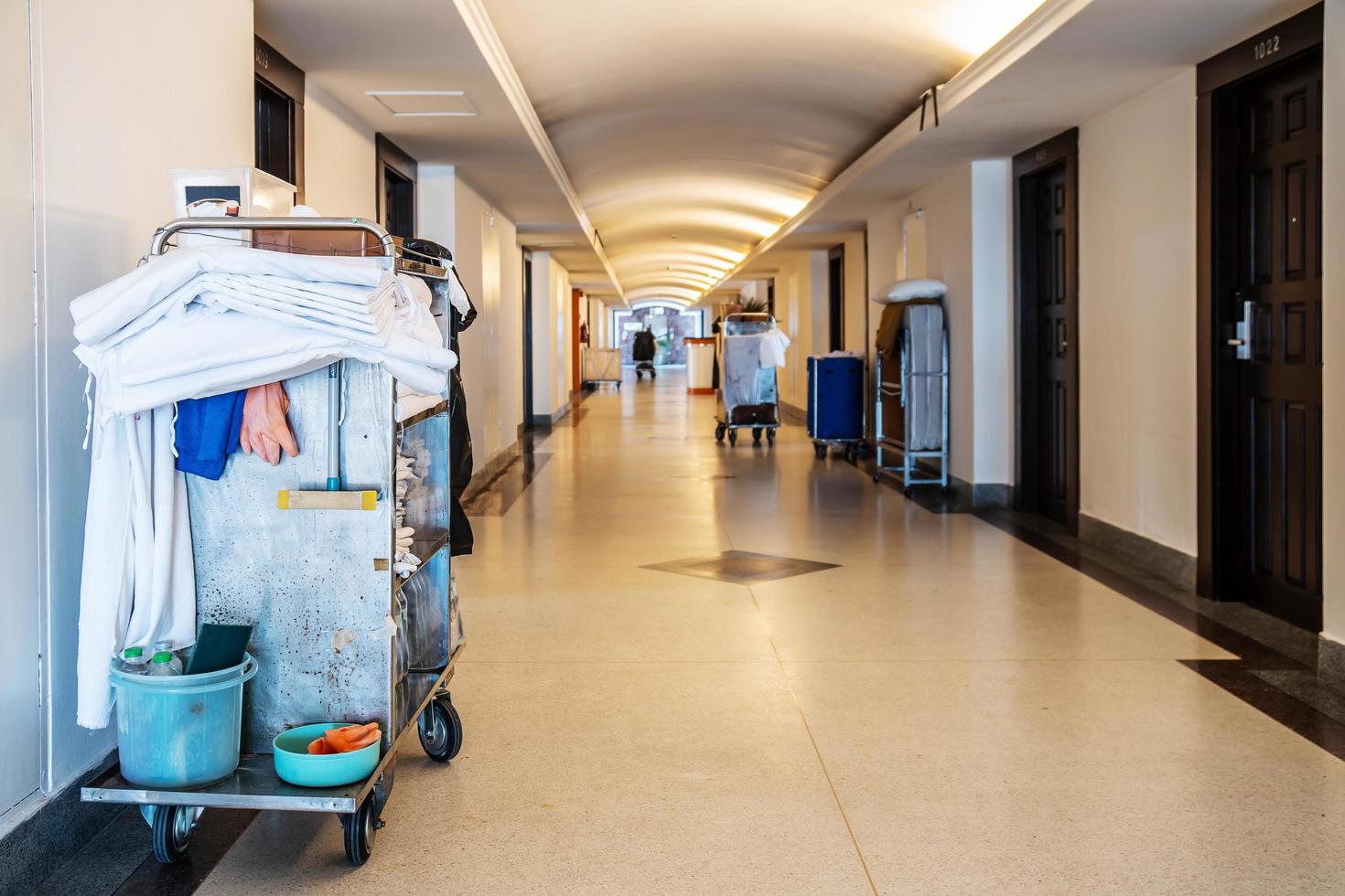 Cleaners trolley with cleaning equipments at hotel, Copy space for text, Concept of room service tool and equipment. photo