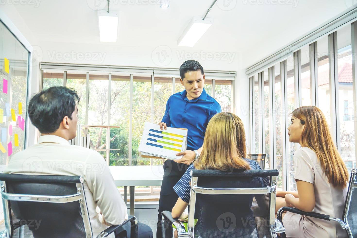 Businessman standing and leading business presentation. Male executive putting his ideas during presentation to plan projects for business and organization development to be successful in meeting room photo