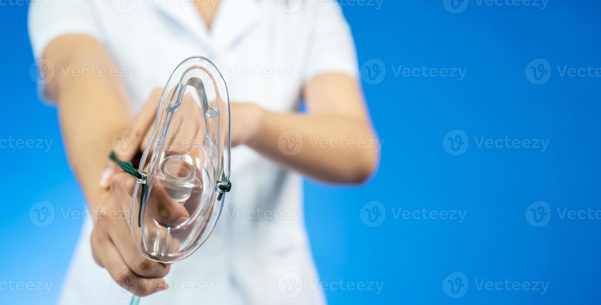 Doctor puts on oxygen mask to connect a patient losing consciousness to an artificial respiration device, Emeregency and first aid concept. photo