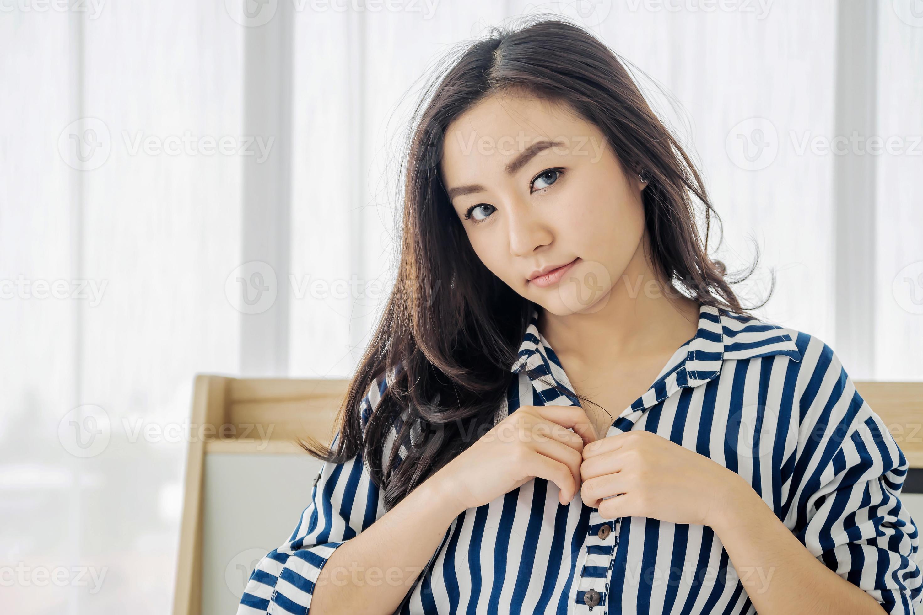 Images of young asian woman going to take off shirts By beginning to remove the buttons to begin pleasure, sex concept photo