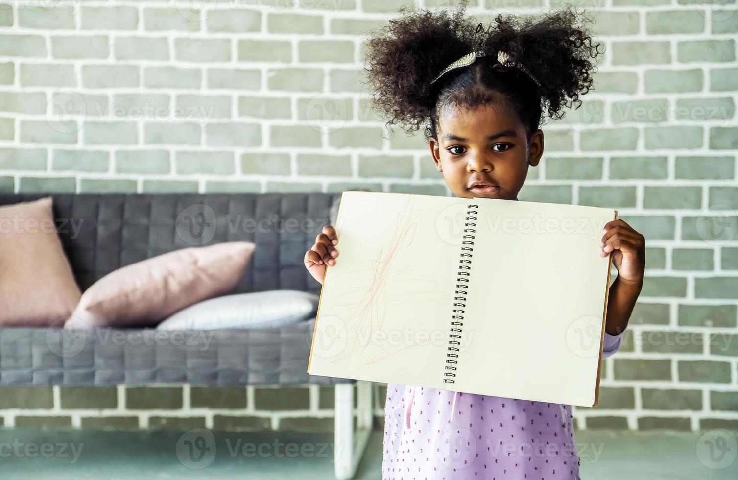 Cute black african american little girl showing self drawn painting,  African people - Children photo