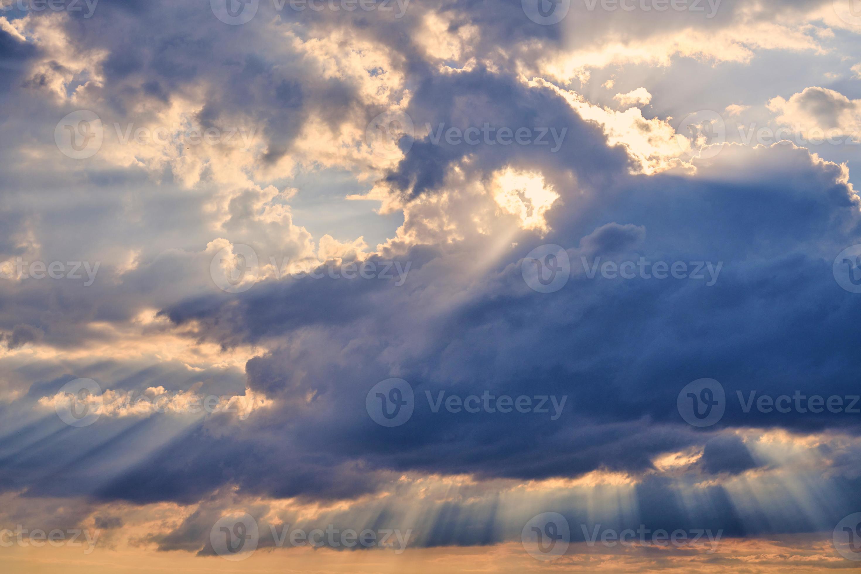 Sun rays and clouds, sunbeams shining through cumulus clouds, stunning