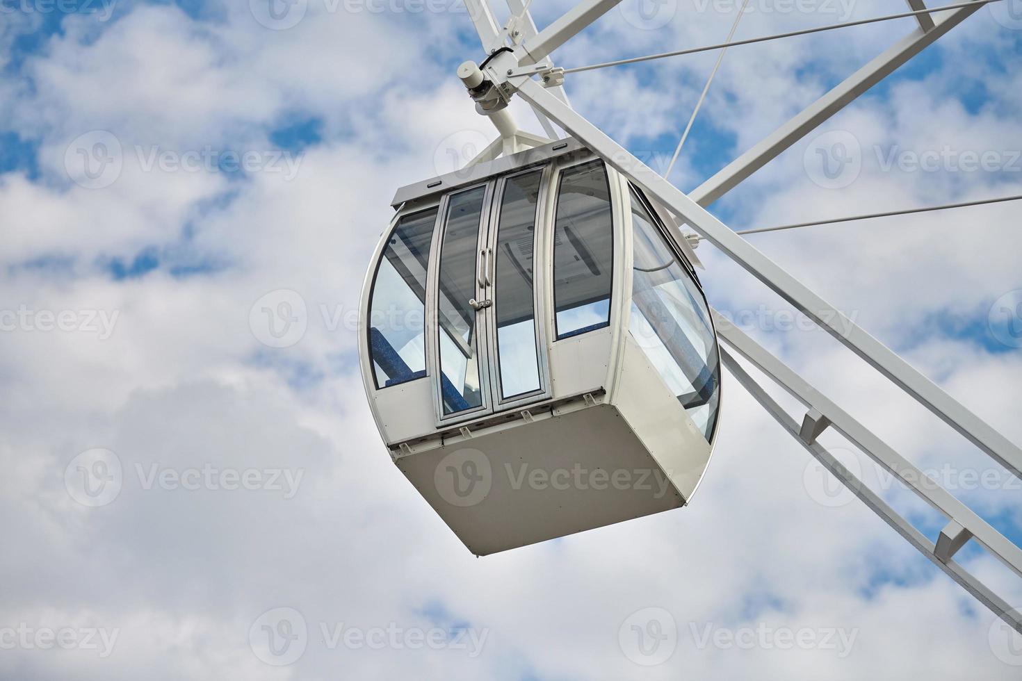 Ferris wheel cabin in amusement park close up blue sky background, Bird's Eye view attraction photo