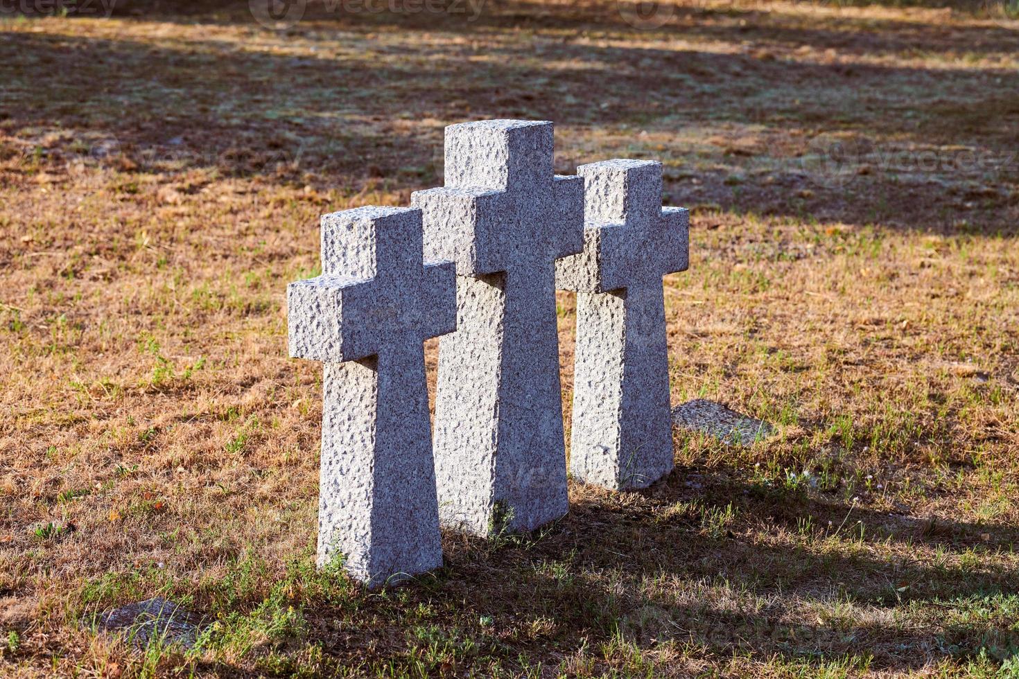 Three catholic stone crosses in German military cemetery, Baltiysk, Russia photo