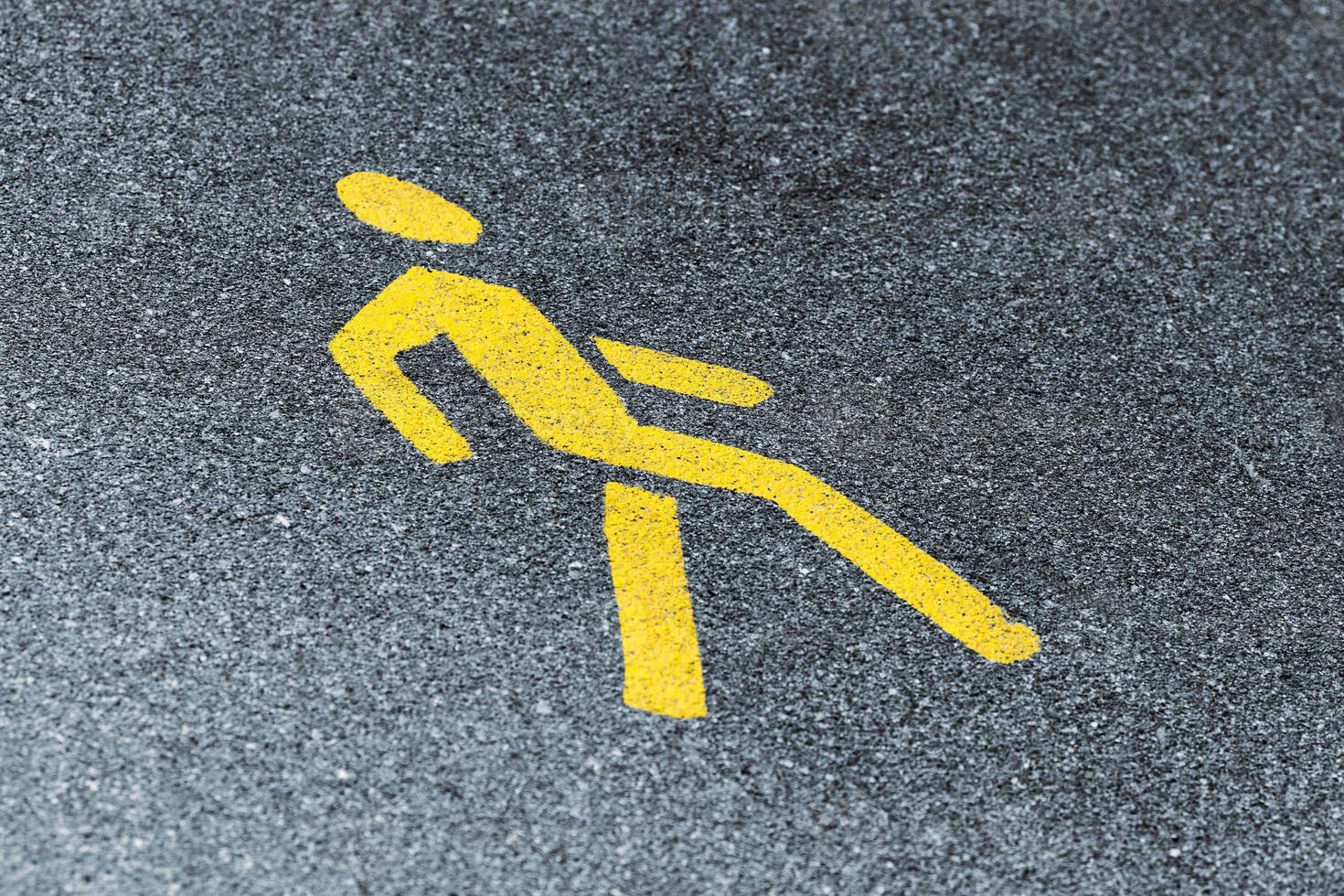 Yellow pedestrian sign on sidewalk, road yellow marking for traffic safety near highway photo