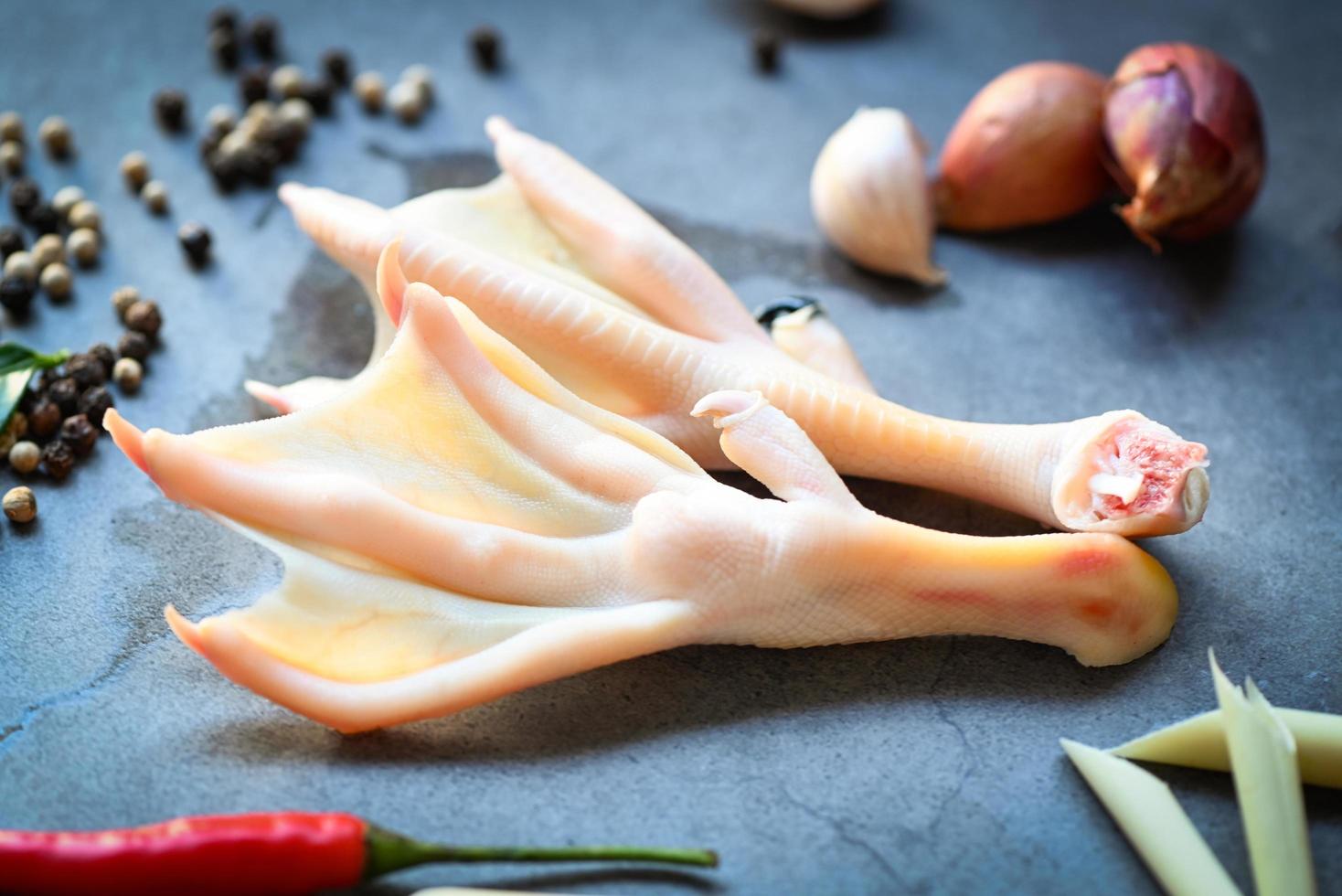 duck feet with herb spices ready to cook on plate, Fresh feet duck for food photo