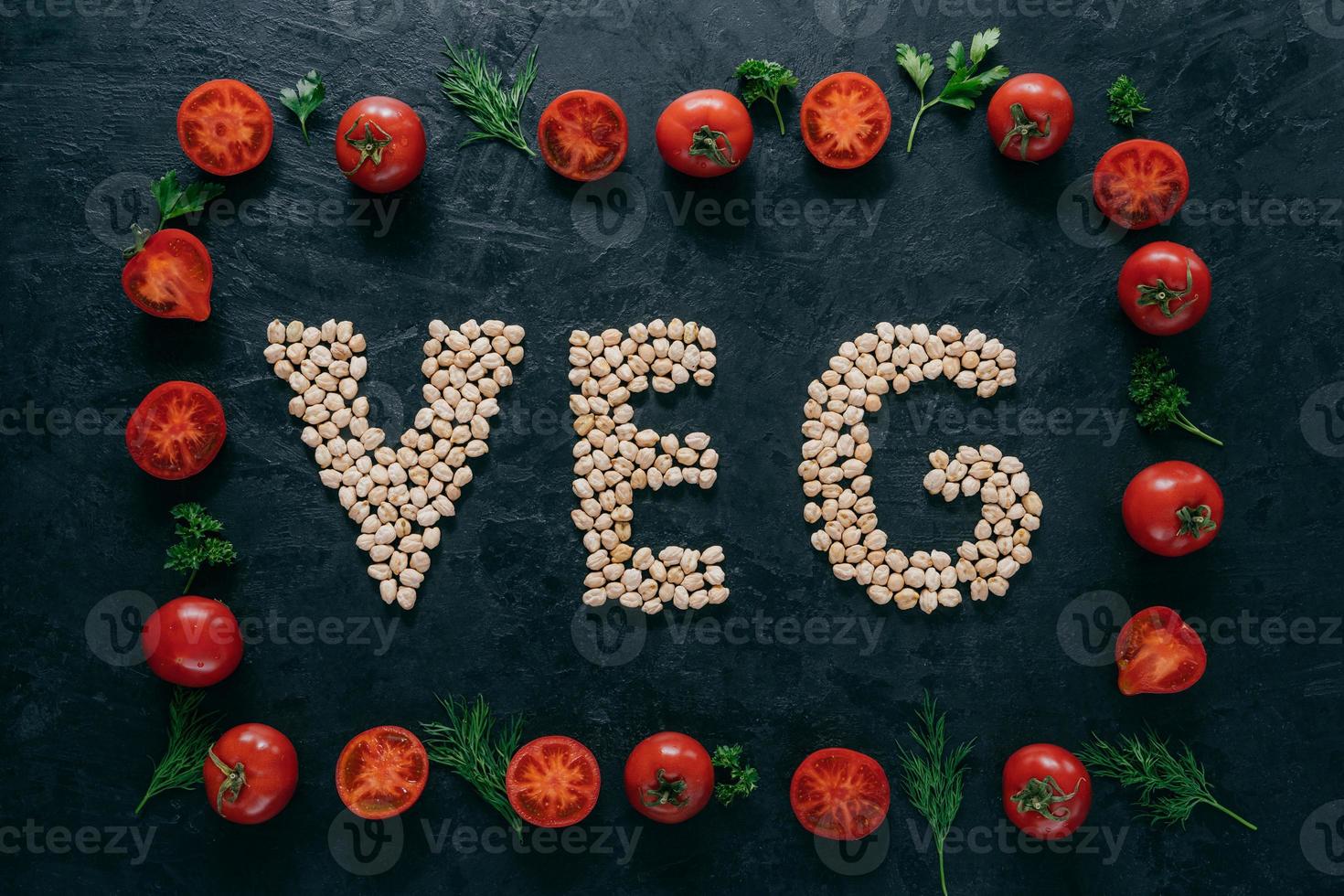 Vegetable frame made of tomatoes and green parsley, dill. Letter shaped garbanzo in middle. Raw vegetarian products. Healthy eating concept photo