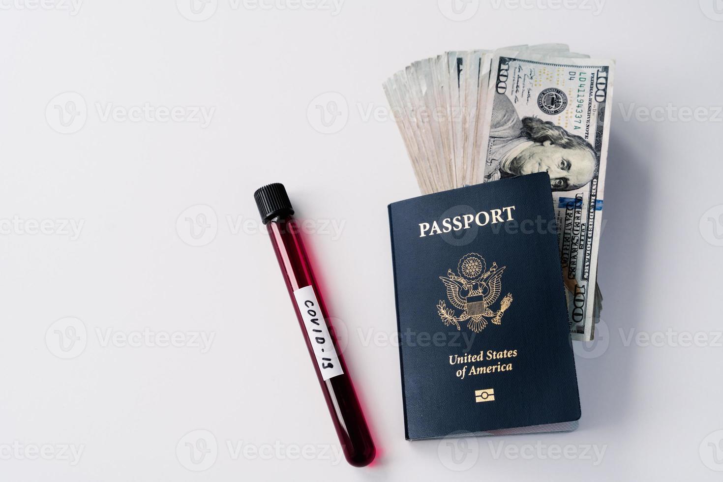 Horizontal shot of blood sample in tube for coronavirus testing, passport and money banknotes. Travel prohibition during quarantine. Covid-19 spread in world photo