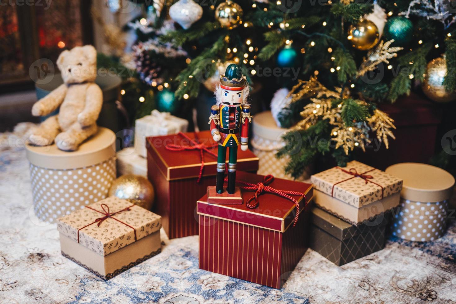 Many gifts under decorated New Year tree. Home interior and festive atmosphere. Winter holidays concept. Horizontal picture with many wrapped gifts. Calm atmosphere and festive event. photo