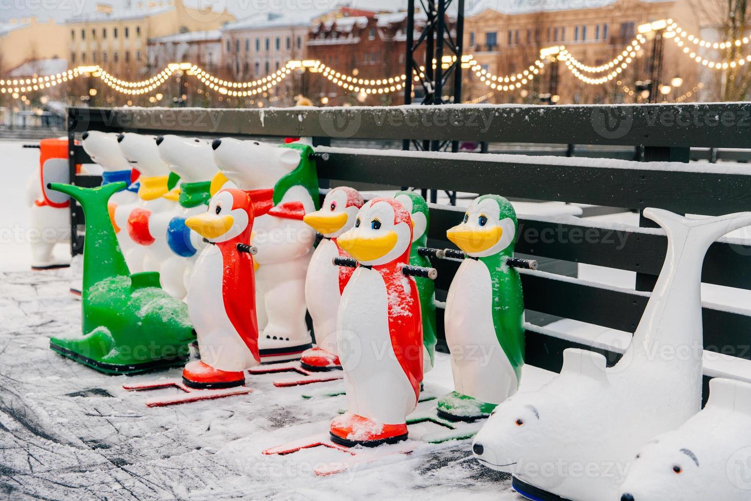 Special figures made in shape of animals stand on ice rink, used by beginners who learn ice skating. Skate aid. Things needed for skating and keeping balance photo