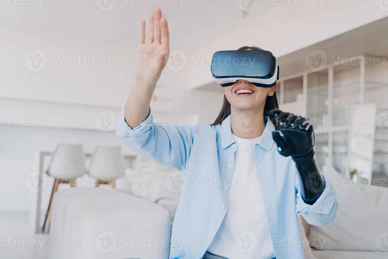 Handicapped girl gets rehabilitation in vr glasses. Amputee with bionic limb prosthesis. photo