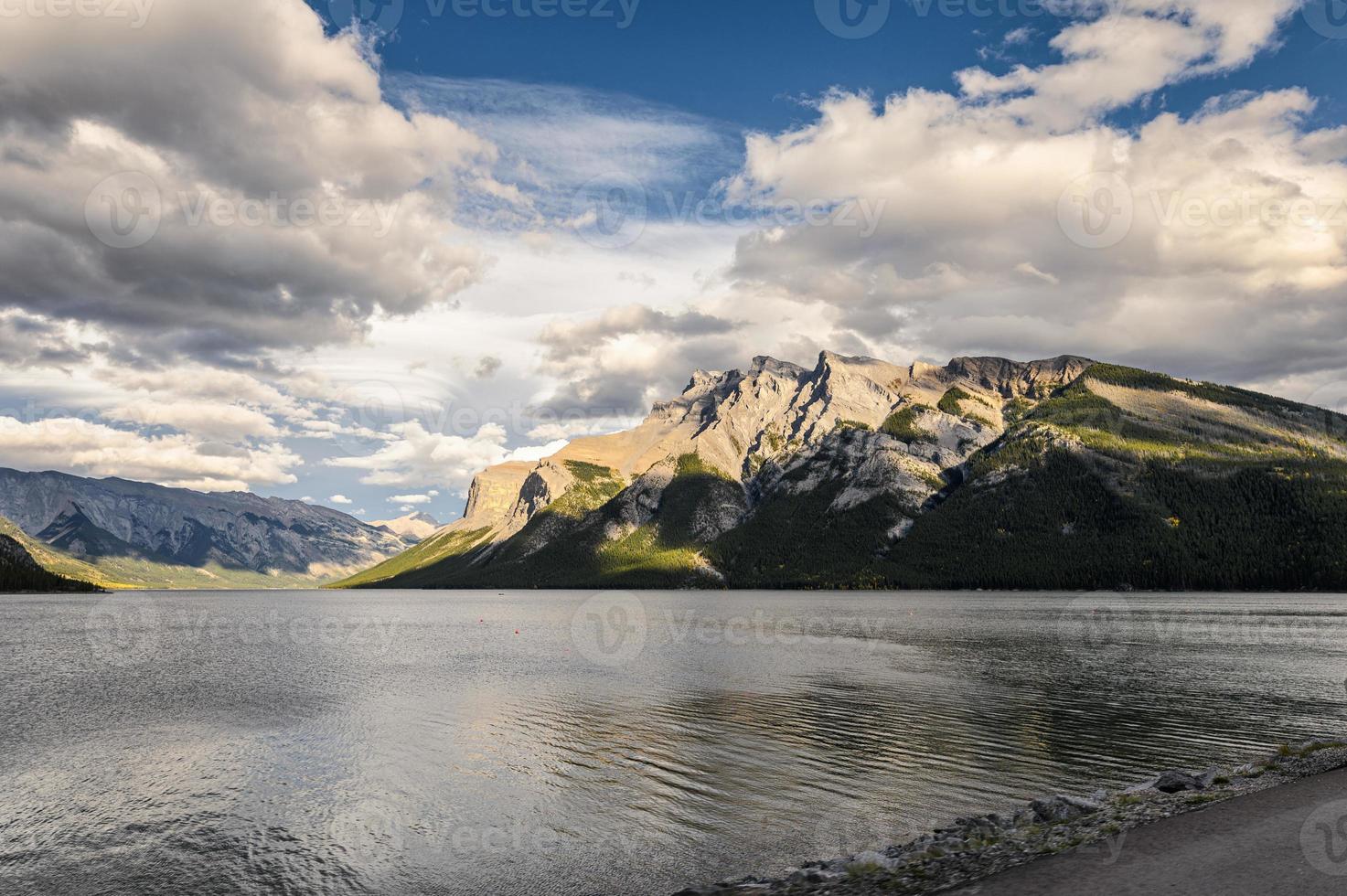 Lake Minnewanka with sunlight on rocky mountains at Banff national park photo