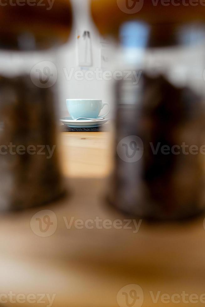 Cup of hot cappuccino coffee on table photo