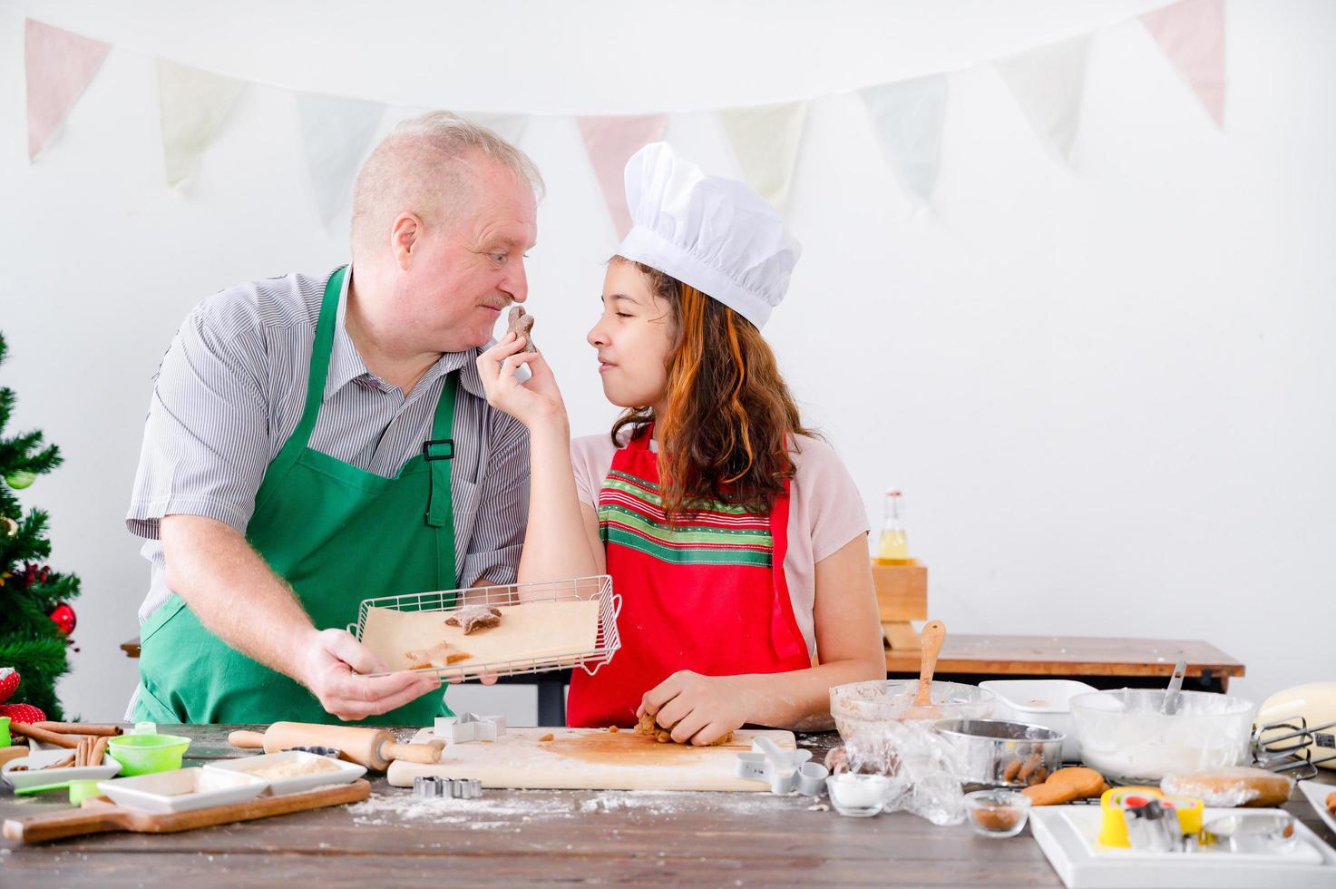 A young European girl and her father tests out the gingerbread she does during Christmas and New Years photo