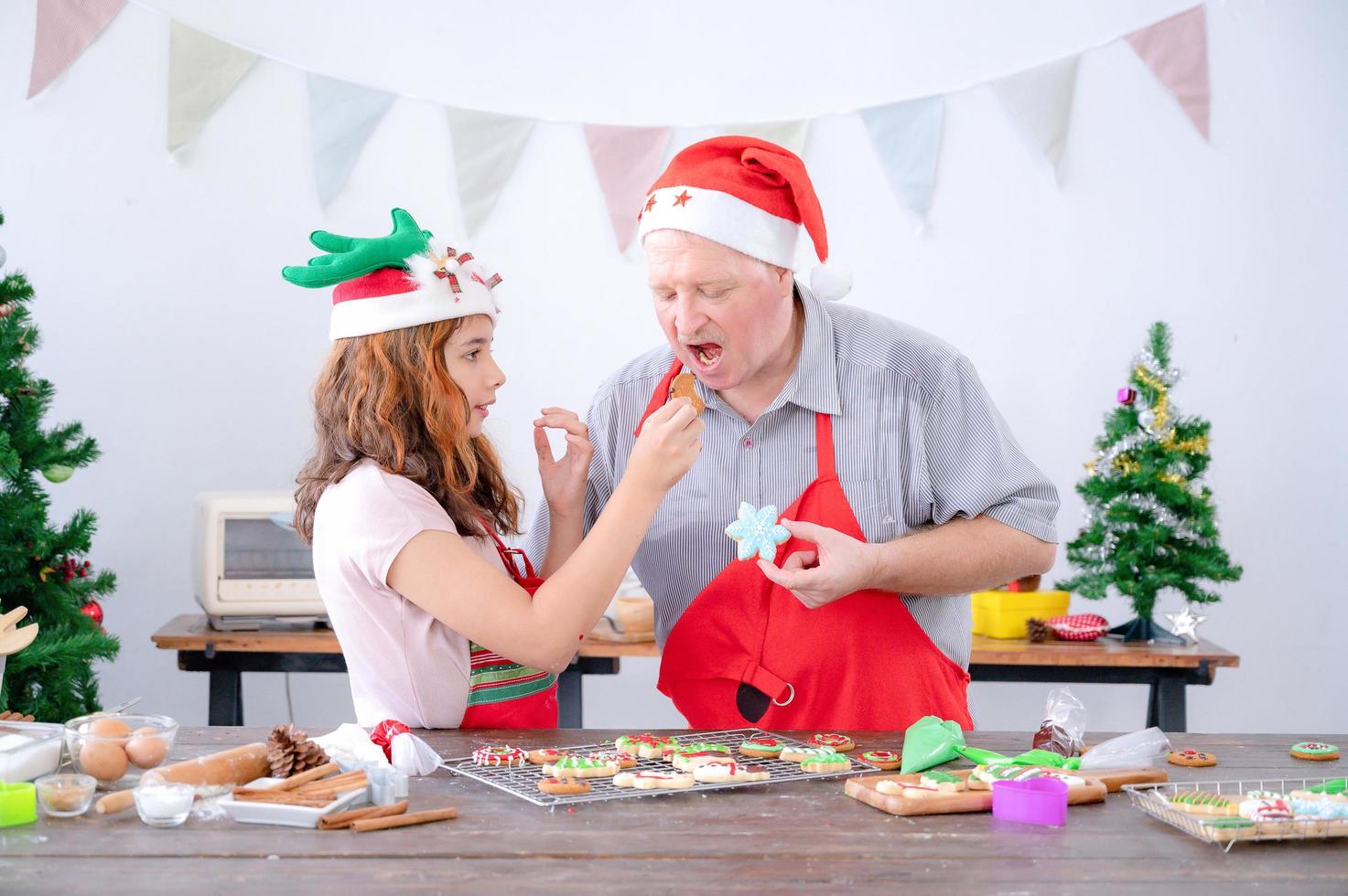 A young European girl and her father tests out the gingerbread she does during Christmas and New Years photo