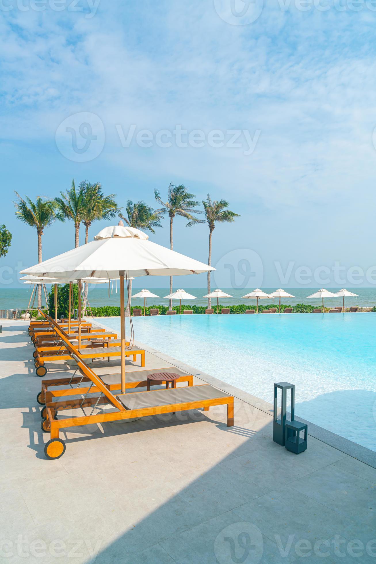 umbrella with bed pool around swimming pool with ocean sea background