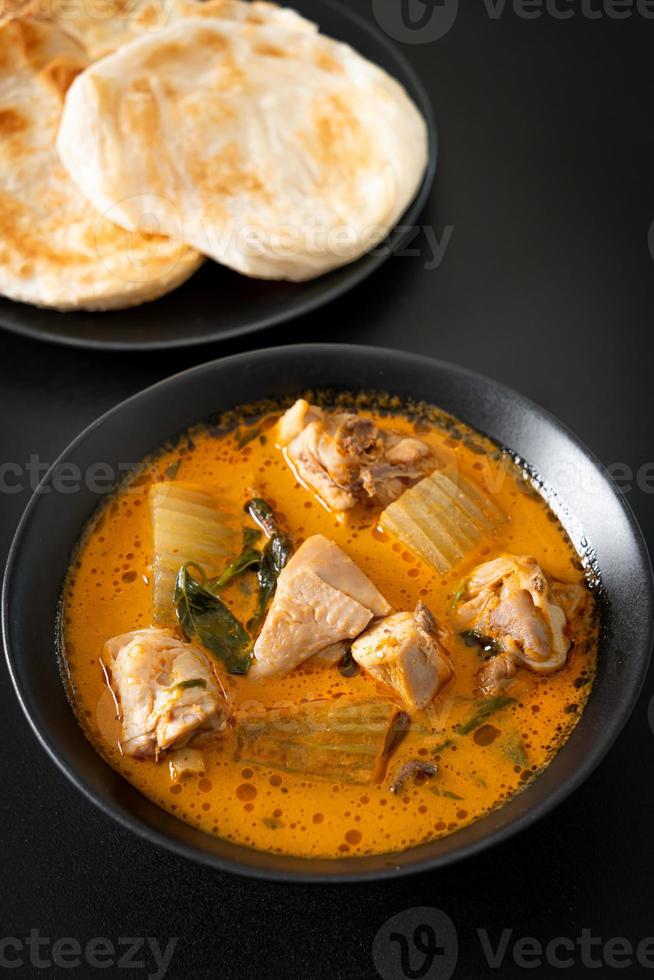 Chicken curry soup with roti photo