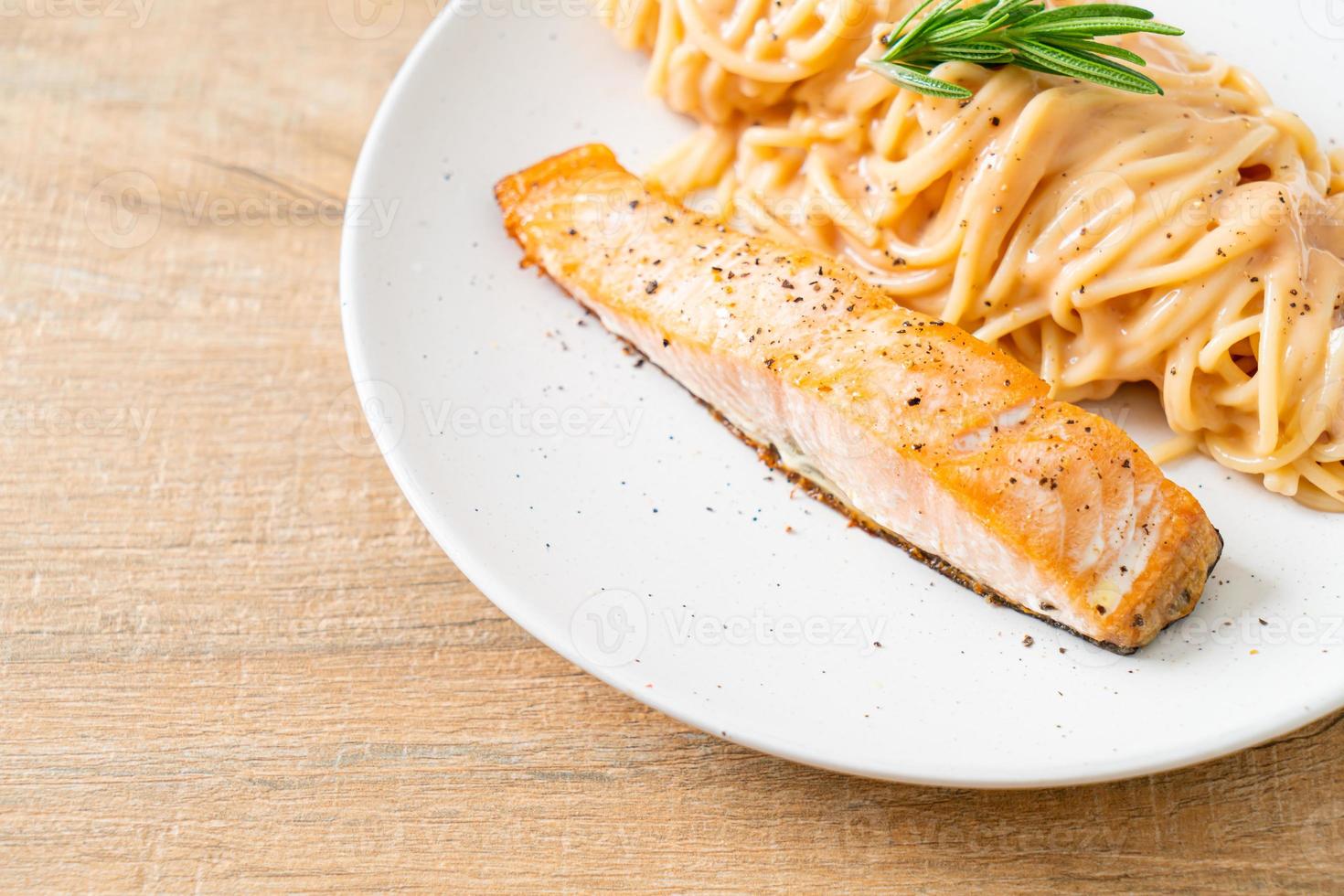 Salmón a la parrilla con espagueti salsa cremosa de tomate foto