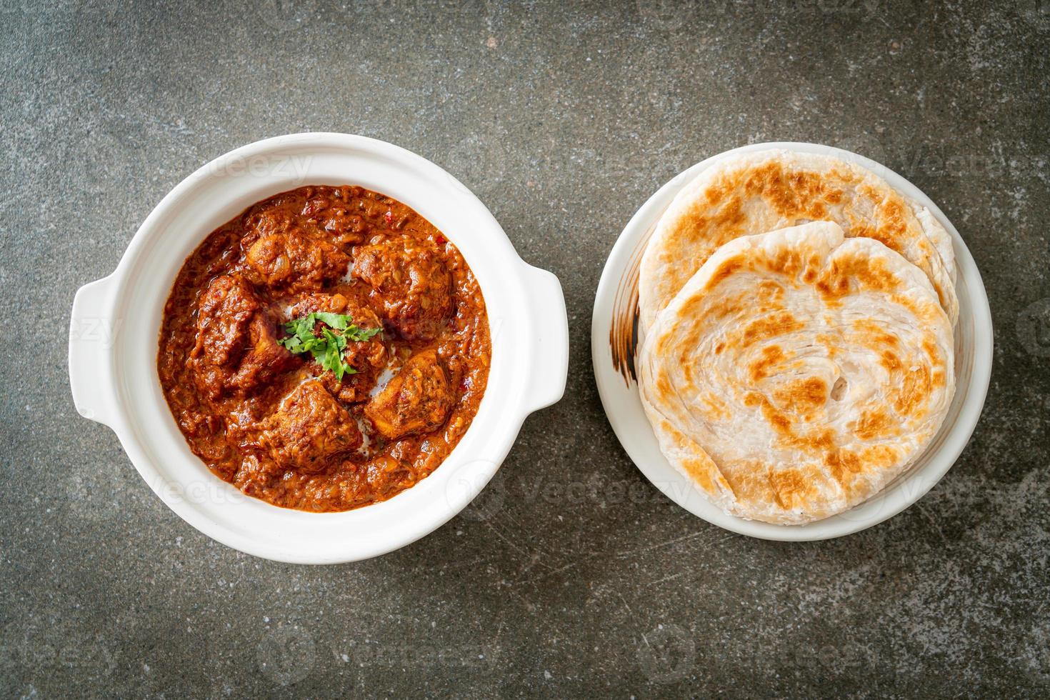 chicken tikka masala spicy curry meat food with roti or naan bread photo