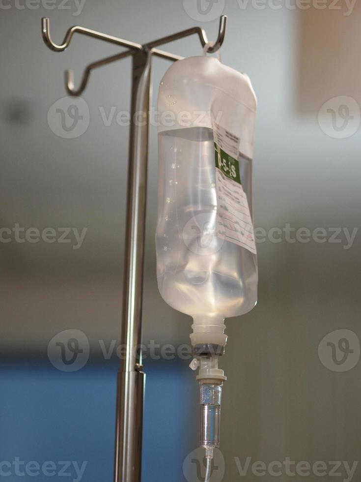 Set IV saline bottle solution Fluid filled in pediatric patient hand in the hospital photo