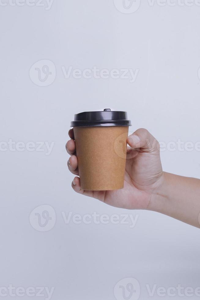 Hand holding paper cup isolated on white background. Realistic set mock up for branding,  template for your design, presentation, promo, ad. photo