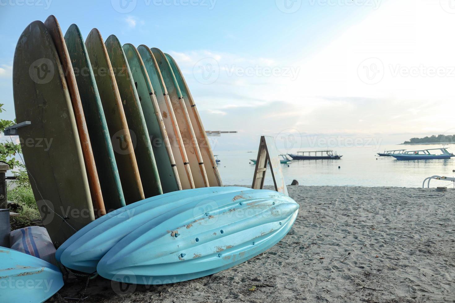 Rows of surfer boards parking in sandy beach photo